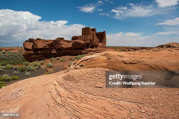 Red rocks in the foreground of the remains of the Wukoki Pueblo in the Wupatki National Monument Park in northern Arizona, USA, where the Northern...