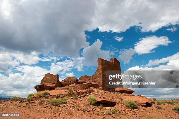 Red rocks in the foreground of the remains of the Wukoki Pueblo in the Wupatki National Monument Park in northern Arizona, USA, where the Northern...