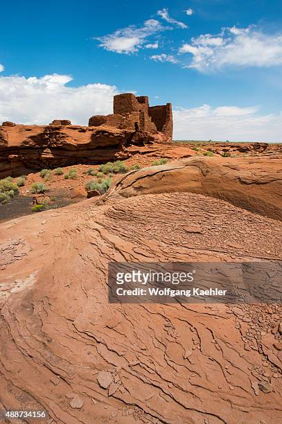 Red rocks in the foreground of the remains of the Wukoki Pueblo in the Wupatki National Monument Park in northern Arizona, USA, where the Northern...