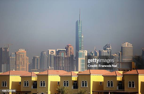 Skyscrapers is seen behind residential villas in Jumeirah Park on September 15, 2015 in Dubai, United Arab Emirates.