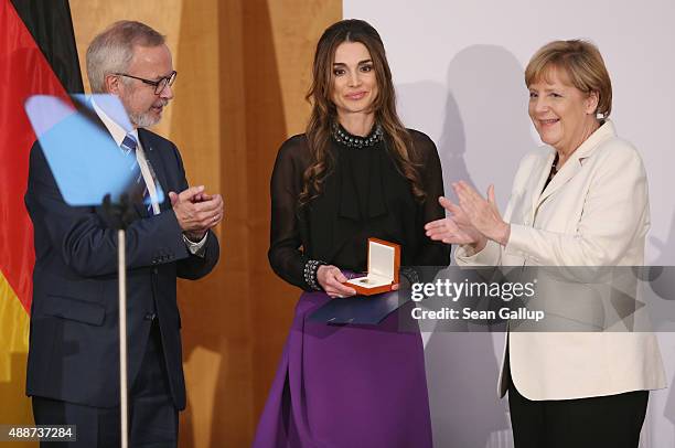 Queen Rania of Jordan smiles after receiving the Walther Rathenau Award from German Chancellor Angela Merkel as Walther Rathenau Institute Chairman...