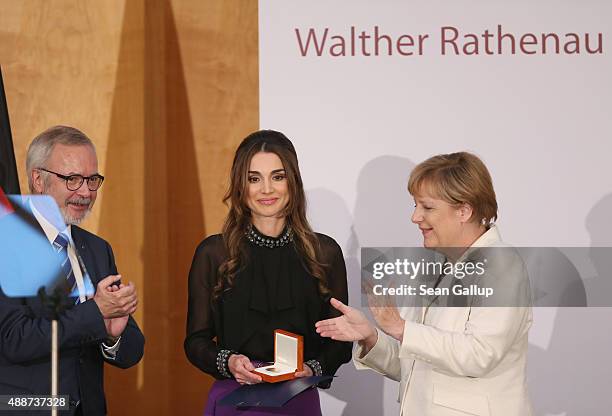 Queen Rania of Jordan smiles after receiving the Walther Rathenau Award from German Chancellor Angela Merkel as Walther Rathenau Institute Chairman...