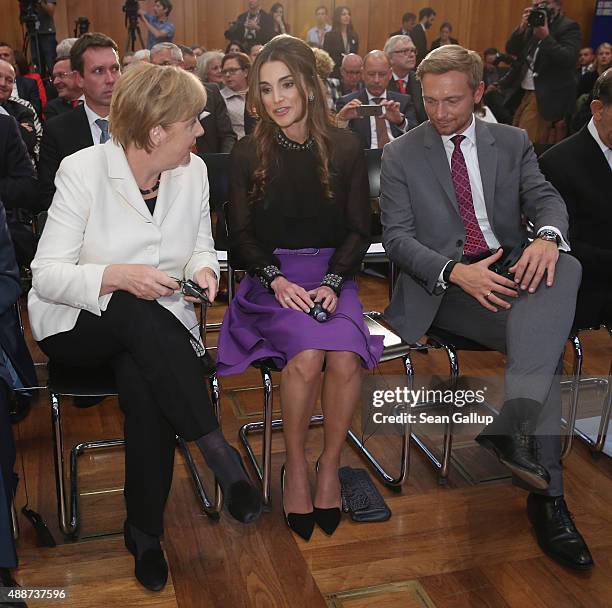 Queen Rania of Jordan chats with German Chancellor Angela Merkel as German politician Christian Lindner looks on at the Walther Rathenau Award...
