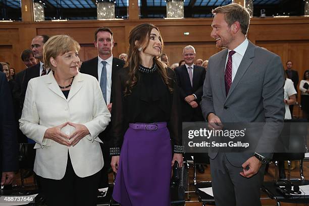 Queen Rania of Jordan chats with German Chancellor Angela Merkel and German politician Christian Lindner at the Walther Rathenau Award ceremony on...
