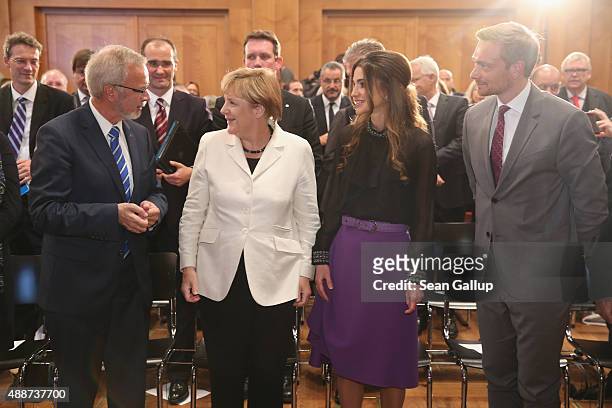 Queen Rania of Jordan smiles after receiving the Walther Rathenau Award from German Chancellor Angela Merkel as Walther Rathenau Institute Chairman...