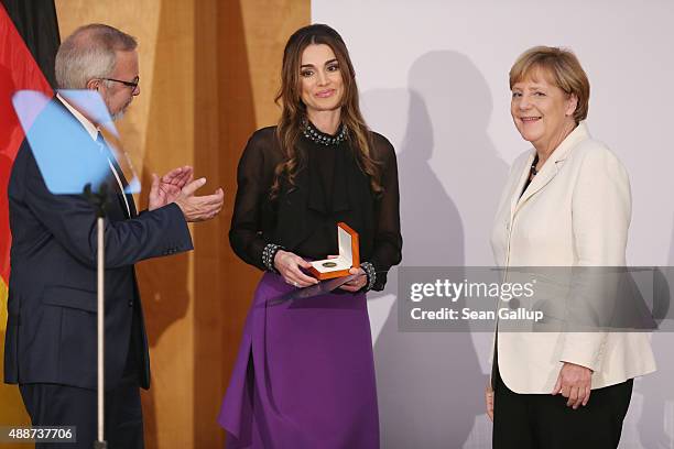 Queen Rania of Jordan smiles after receiving the Walther Rathenau Award from German Chancellor Angela Merkel as Walther Rathenau Institute Chairman...