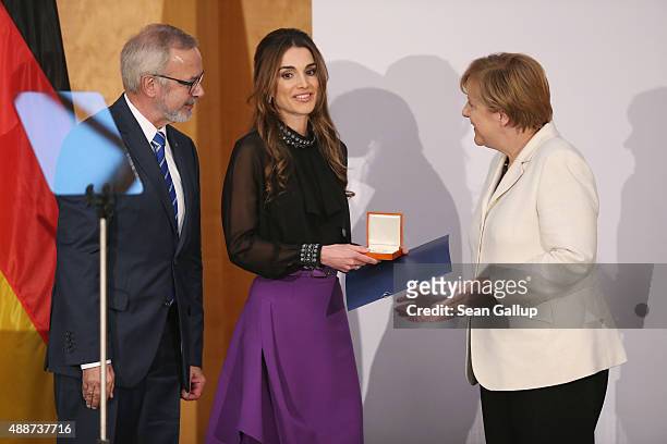 Queen Rania of Jordan smiles after receiving the Walther Rathenau Award from German Chancellor Angela Merkel as Walther Rathenau Institute Chairman...