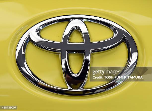 The crest badge of a Toyota Vitz is pictured at Toyota Motors' Tokyo headquarters on May 8, 2014. Toyota posted a record annual net profit of 17.9...