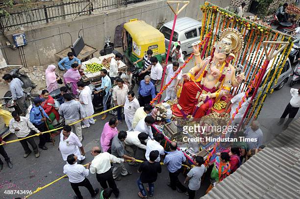 Devotees participate in Shobha Yatra and Mangal Murti Sthapna in Delhi Ka Maharaja, a Ganesh Mahotsav celebration by Ganesh Sewa Mandal in Laxmi...