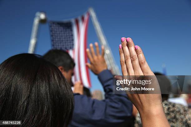 One hundred immigrants become American citizens during a naturalization ceremony at Liberty State Park on September 17, 2015 in Jersey City, New...