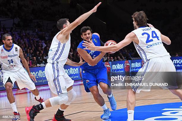 Italy's small forward Alessandro Gentile dribbles his way through Czech Republic's power forward Petr Benda and Czech Republic's power forward Jan...