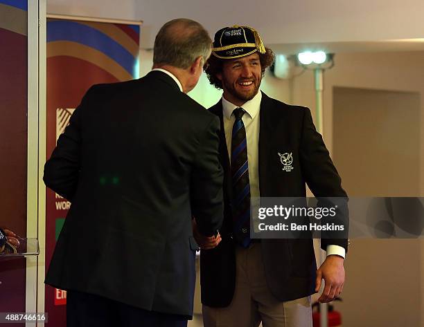 Namibia captain Jacques Burger recieves his cap from Chairman of World Rugby Bernard Lapasset during the RWC 2015 Welcome Ceremony for Namibia at...