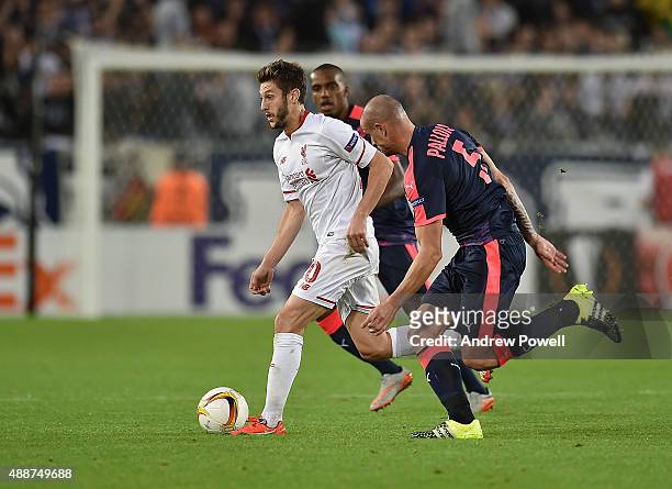 Adam Lallana of Liverpool competes with Nicolas Pallois of FC Girondins de Bordeaux during the UEFA Europa League match between FC Girondins de...