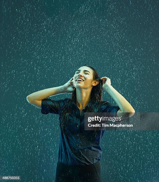 woman smiling in the rain - positive emotion stock pictures, royalty-free photos & images