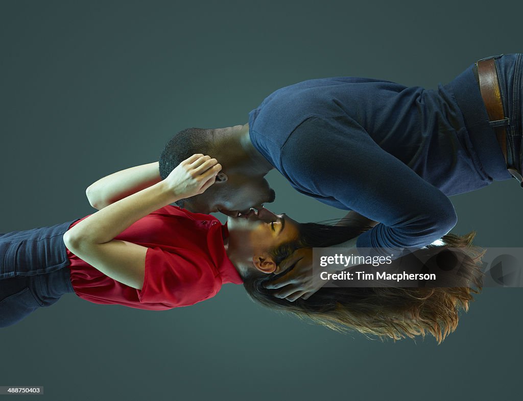 Couple kissing, floating in mid air