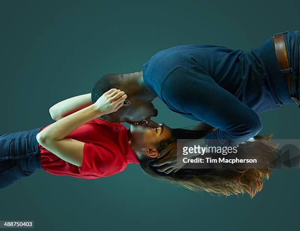 couple kissing, floating in mid air - young couple kiss ストックフォトと画像