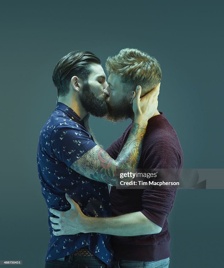 Two bearded men kissing