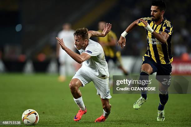 Molde's Mattias Mostrom vies for the ball with Fenerbahce Alper Potuk during the Europa League football match between Fenerbahce and Molde on...