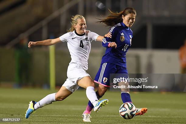 Homare Sawa of Japan and Katie Hoyle of New Zealand in action during the women's international friendly match between Japan and New Zealand at Nagai...