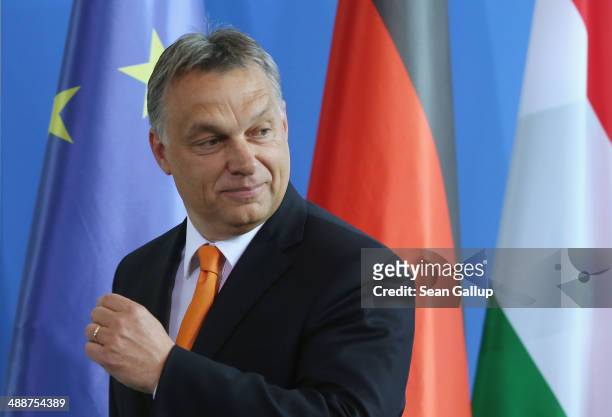 Hungarian Prime Minister Viktor Orban and German Chancellor Angela Merkel depart after speaking to the media prior to talks at the Chancellery on May...
