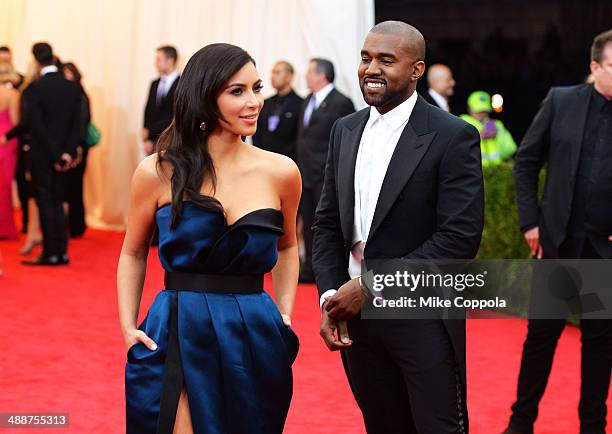 Kim Kardashian and Kanye West attend the "Charles James: Beyond Fashion" Costume Institute Gala at the Metropolitan Museum of Art on May 5, 2014 in...