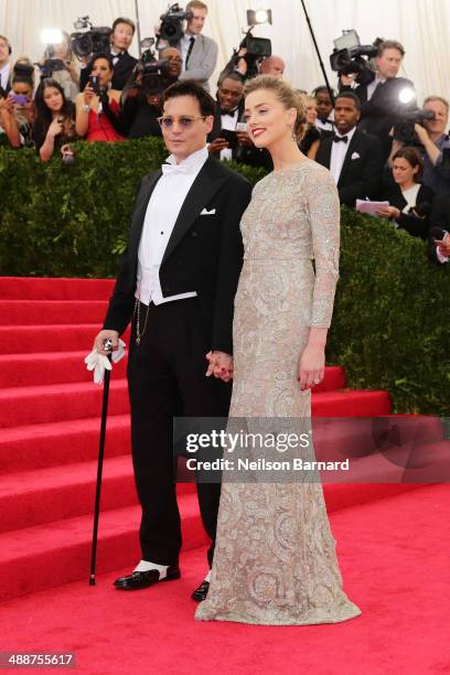 Johnny Depp and Amber Heard attend the "Charles James: Beyond Fashion" Costume Institute Gala at the Metropolitan Museum of Art on May 5, 2014 in New...