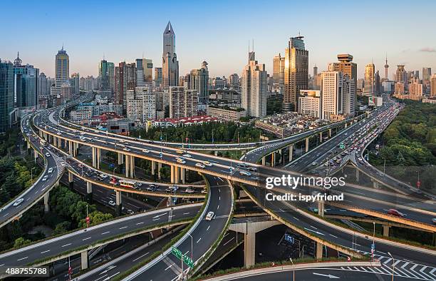 moderne stadt mit highway-anschlussstelle - shanghai aerial view motorway skyline stock-fotos und bilder