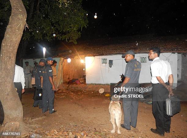 Indian security officials stand guard outside a house where an explosion took place in the village of Chandor near Margao in the southern Indian...