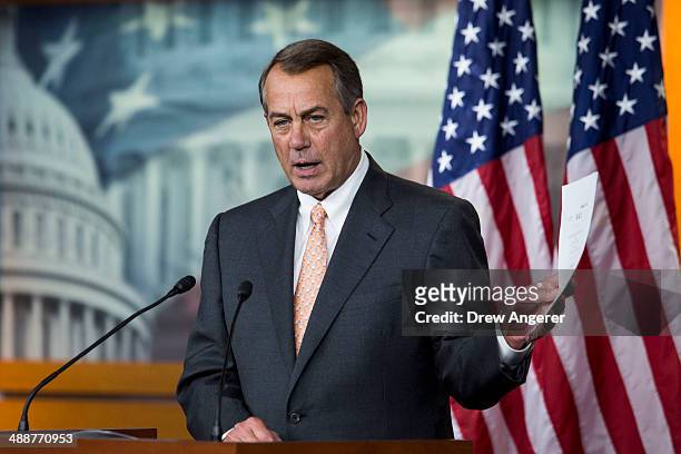 Speaker of the House John Boehner holds up a copy of legislation concerning the Keystone XL Pipeline during his weekly news conference on Capitol...