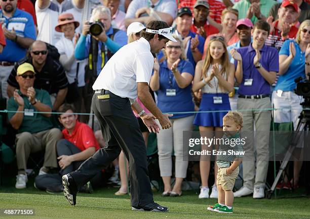 Bubba Watson of the United States celebrates with his son Caleb on the 18th green after winning the 2014 Masters Tournament by a three-stroke margin...