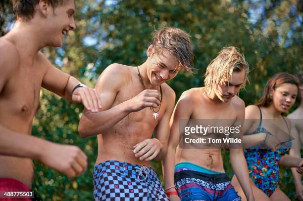 friends sharing a joke whilst standing in nature - boy with long hair stock pictures, royalty-free photos & images