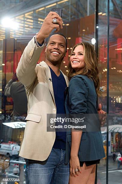 Calloway interviews Chrissy Teigen during her visit to "Extra" at their New York studios at H&M in Times Square on May 8, 2014 in New York City.