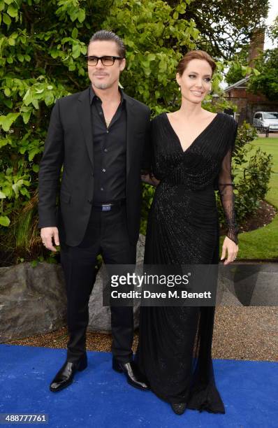 Brad Pitt and Angelina Jolie arrive at a private reception as costumes and props from Disney's "Maleficent" are exhibited in support of Great Ormond...