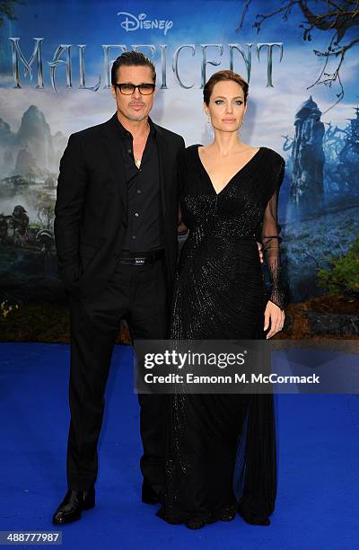 Brad Pitt and Angelina Jolie attend a private reception as costumes and props from Disney's "Maleficent" are exhibited in support of Great Ormond...