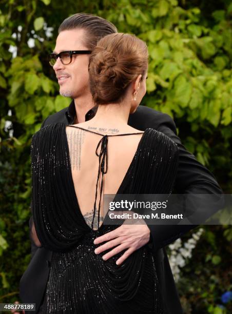 Brad Pitt and Angelina Jolie arrive at a private reception as costumes and props from Disney's "Maleficent" are exhibited in support of Great Ormond...