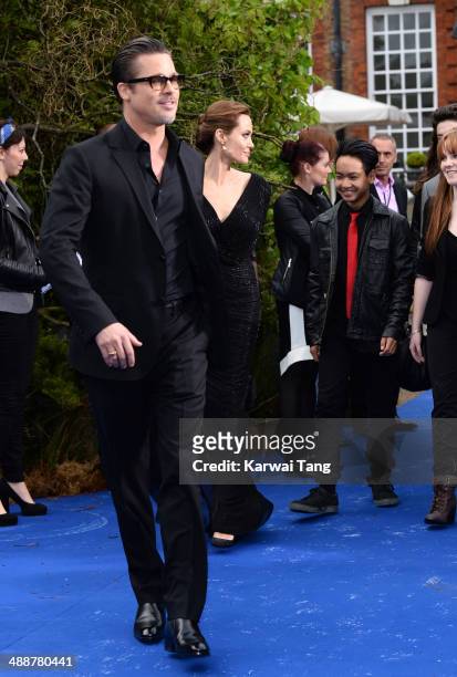 Brad Pitt, Angelina Jolie and Maddox Jolie-Pitt attend a private reception as costumes and props from Disney's "Maleficent" are exhibited in support...