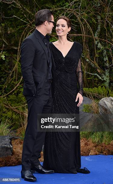 Brad Pitt and Angelina Jolie attend a private reception as costumes and props from Disney's "Maleficent" are exhibited in support of Great Ormond...