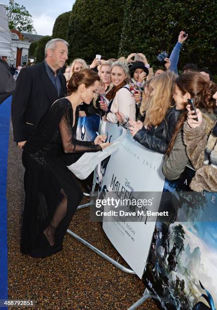 Angelina Jolie meets fans at a private reception as costumes and props from Disney's "Maleficent" are exhibited in support of Great Ormond Street...