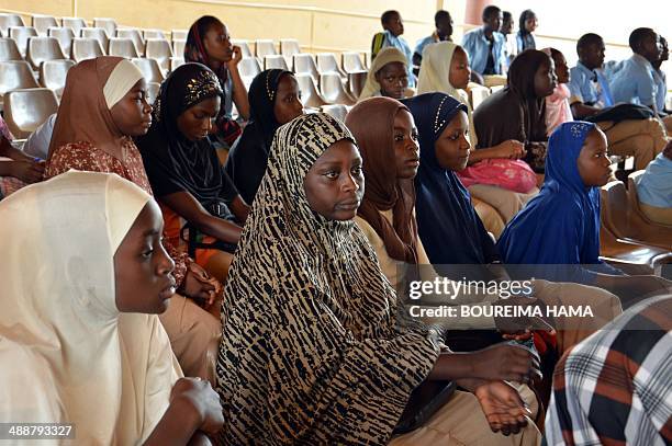 Women sit as they gather on May 8, 2014 during a meeting called by Congafen at the Youth house in Niamey, western Niger, to ask the United Nations to...