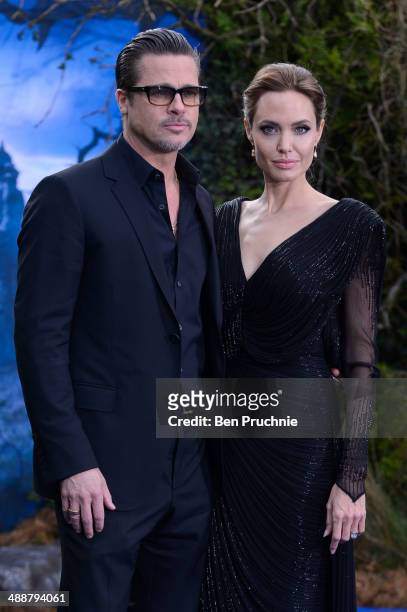 Brad Pitt and Angelina Jolie attend a private reception as costumes and props from Disney's "Maleficent" are exhibited in support of Great Ormond...