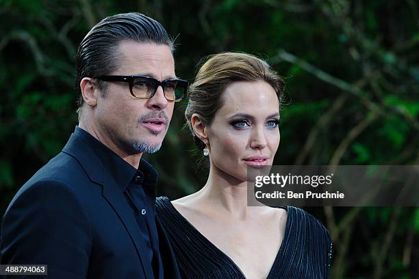 Brad Pitt and Angelina Jolie attend a private reception as costumes and props from Disney's "Maleficent" are exhibited in support of Great Ormond...