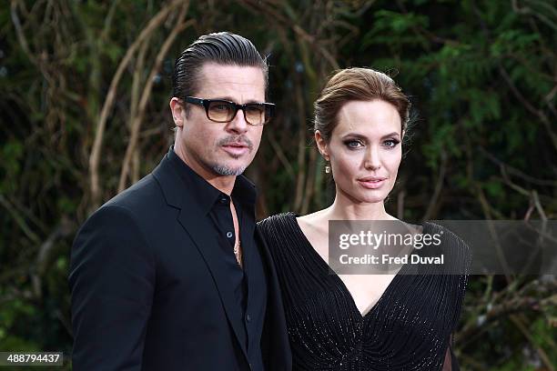 Brad Pitt and Angelina Jolie attend a private reception as costumes and props from Disney's "Maleficent" are exhibited in support of Great Ormond...