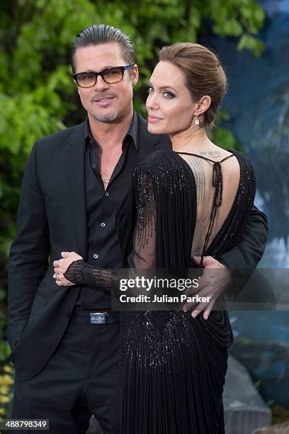 Brad Pitt and Angelina Jolie attend a private reception as costumes and props from Disney's "Maleficent" are exhibited in support of Great Ormond...