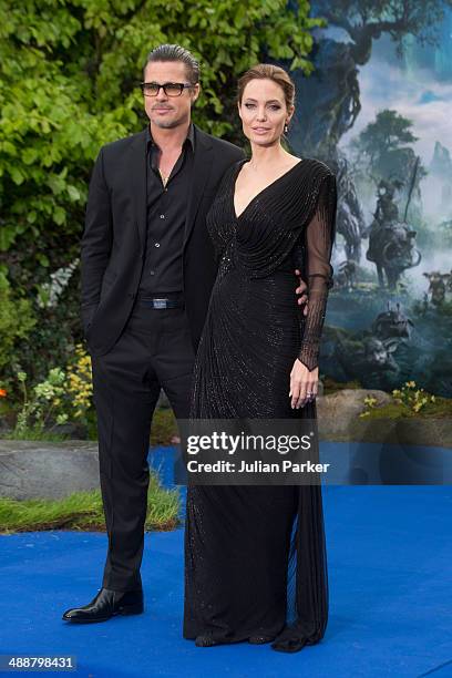 Brad Pitt and Angelina Jolie attend a private reception as costumes and props from Disney's "Maleficent" are exhibited in support of Great Ormond...