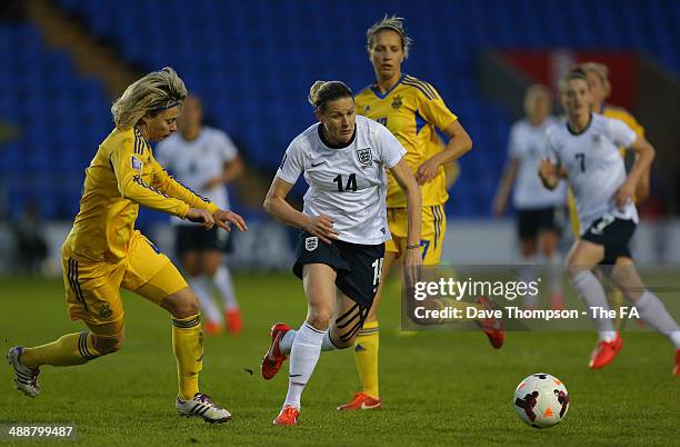 Kelly Smith of England gets away from Valentyna Kotyk of Ukraine during the FIFA Women's World Cup Qualifier between England and Ukraine at the...