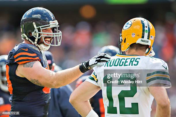 Jared Allen of the Chicago Bears talks with Aaron Rodgers of the Green Bay Packers during a time out at Soldier Field on September 13, 2015 in...