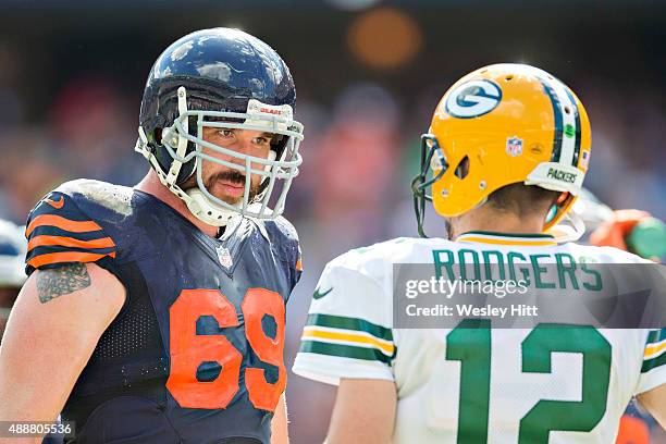 Jared Allen of the Chicago Bears talks with Aaron Rodgers of the Green Bay Packers during a time out at Soldier Field on September 13, 2015 in...