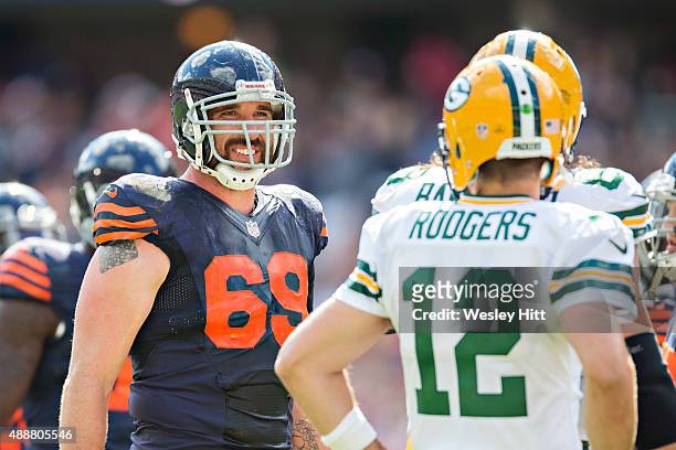 Jared Allen of the Chicago Bears talks with Aaron Rodgers of the Green Bay Packers during a time out at Soldier Field on September 13, 2015 in...