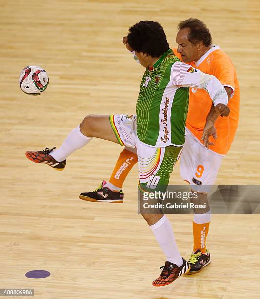 Evo Morales, President of Bolivia fights for the ball with Daniel Scioli, Governor of Buenos Aires during a Copa Juana Azurduy match at Villa La...