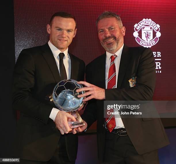 Wayne Rooney of Manchester United is presented with ths Goal of the Season award, for his strike against West Ham United, by Brian McClair at the...